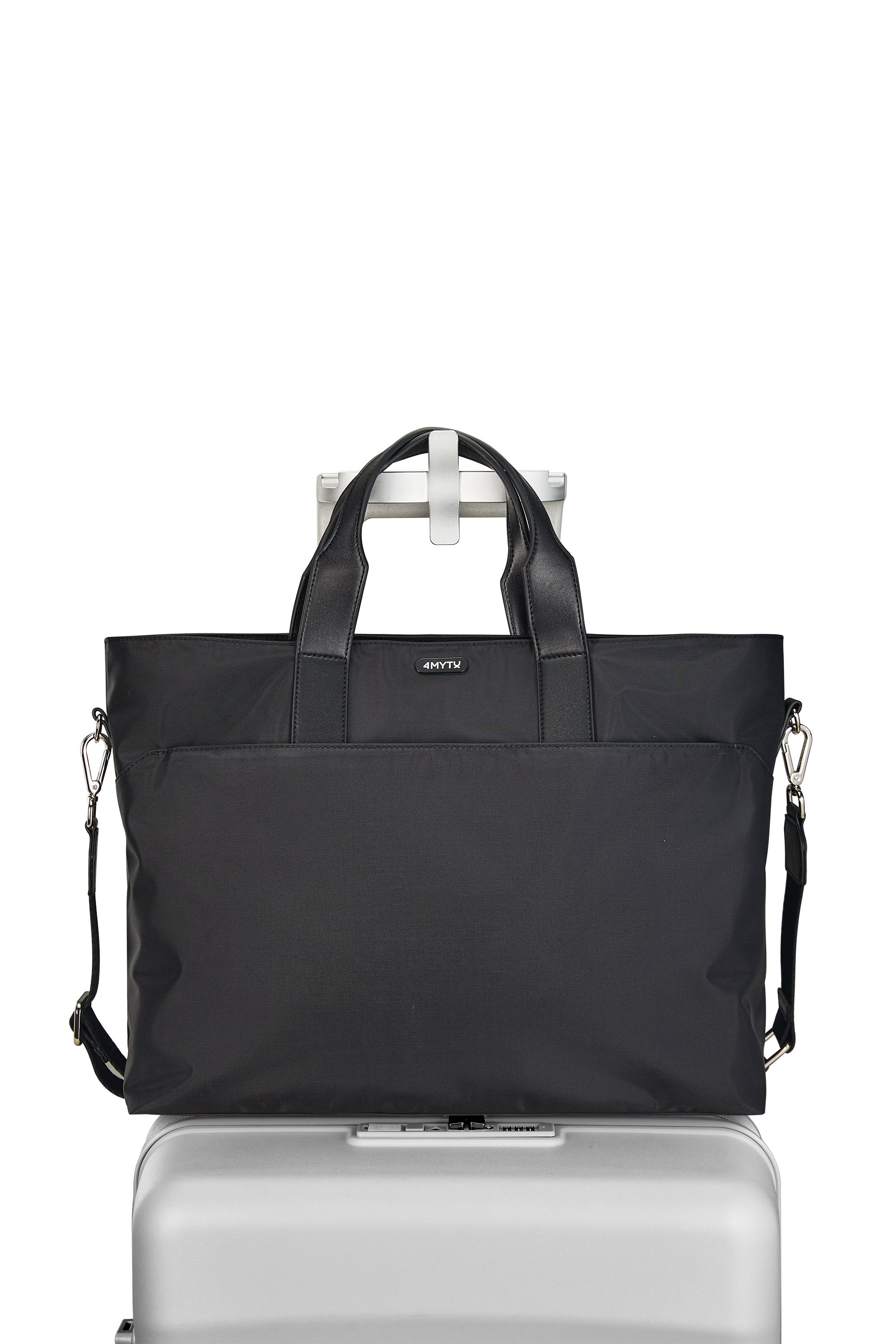 Stylish Jet Black tote bag with top zipper and adjustable strap on suitcase.