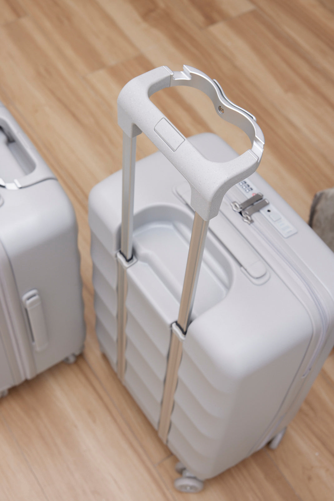 Harbor Mist carry-on suitcase with unique handle and four smooth-rolling wheels.